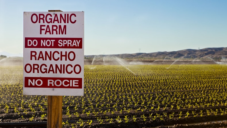 organic farm in US - 'No Spraying' notice at edge of field