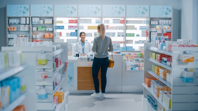 Pharmacist serving a patient at the counter